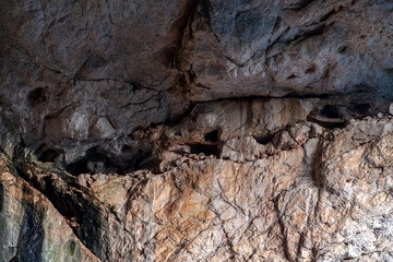 Akmeshit or Akmechet cave. Huge cavern with hole and green trees groving under.