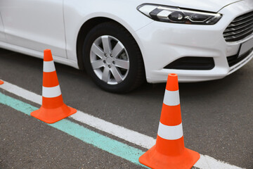 Modern car on test track with traffic cones, closeup. Driving school