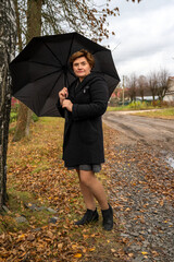 One woman on an autumn walk with an umbrella