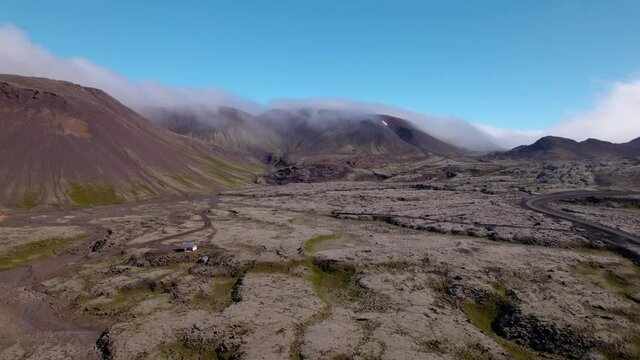 Drone flying over Icelandic other worldly landscape. Old lava field and dormant volcano.