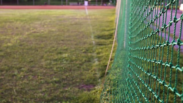 The protective net is in the baseball field.