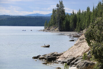 Kayaking near the rocky shoreline of Yellowstone Lake in Yellowstone National Park, Wyoming