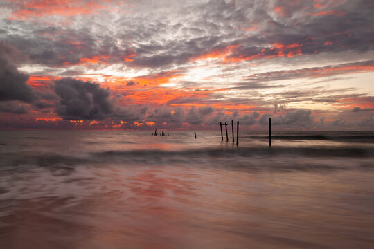 landscape of old wooden bridge with colorful sky in storm cloud