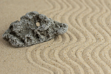 Zen sand garden meditation stone background with copy space. Stones and lines drawing in sand for relaxation. Concept of harmony, balance and meditation, spa, massage, relax