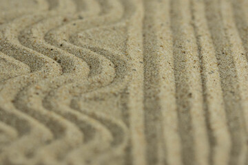 Zen sand garden meditation stone background with copy space. Stones and lines drawing in sand for relaxation. Concept of harmony, balance and meditation, spa, massage, relax