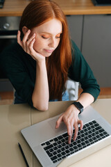 Vertical shot of tired young woman office worker unmotivated and disinterested in dull work with...