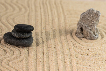Zen sand garden meditation stone background with copy space. Stones and lines drawing in sand for relaxation. Concept of harmony, balance and meditation, spa, massage, relax