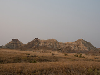Montana's Terry Badlands Striped Mountains with Field of Dried Grass in Golden Light