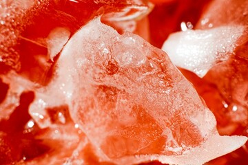 Macro close up of ice in a red reflective cup