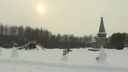 Close - up of a snowman in a hat and scarf . The theme of the Christmas holidays. Happy winter time, early winter morning. Russia - Powered by Adobe
