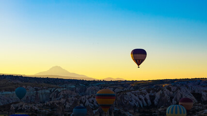Hot air balloons. Hot air balloons in Cappadocia. Mount Erciyes on background.