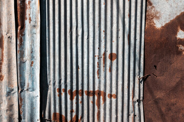 Old and rusty zinc sheet wall. Vintage style metal sheet roof texture. Pattern of old metal sheet. Rusting metal or siding. Corrosion of galvanized. Background and textures in retro concept.