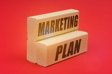 On a red background, wooden blocks with the inscription - MARKETING PLAN