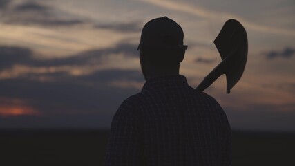 silhouette of a farmer with a shovel, agriculture, go to dig land for garden, preparation for...
