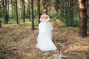 Beautiful wedding bride running in the garden