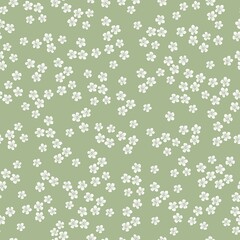 Fond floral vintage. Modèle vectorielle continue pour les imprimés de design et de mode. Motif floral élégant avec de petites fleurs blanches sur fond vert.