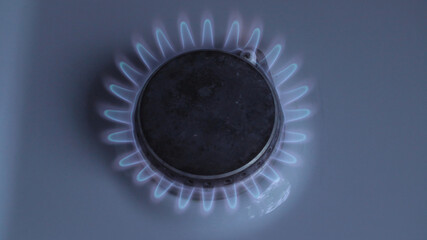 Burning gas stove with blue light, top view