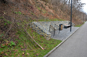 under the slope in the park are new garden rest areas. Cyclists have a public toilet, bathroom, bench and bike rack. the stands have a rhombus shape and everything is designed by a landscape architect