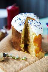 Easter cake with white glaze strewn with cornflowers petals