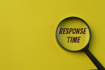 Magnifying glass isolated on a yellow background with text RESPONSE TIME