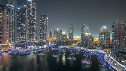 Fototapeta na wymiar Luxury yacht bay in the city aerial night timelapse in Dubai marina