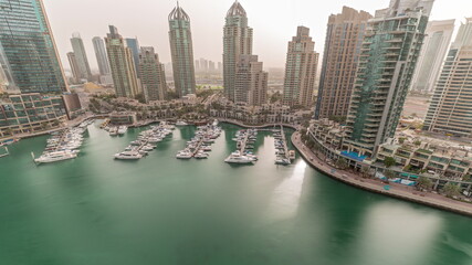Fototapeta na wymiar Luxury yacht bay in the city aerial timelapse in Dubai marina