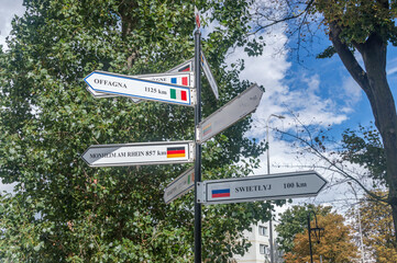 Twin towns fingerpost signage in Malbork. Distances in kilometers in the Malbork city in Poland showing distances to others cities.