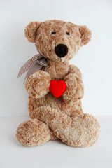 soft toy bear holding a red heart