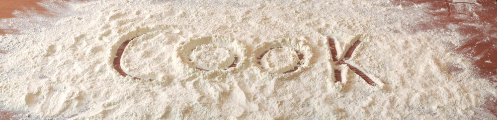 Flour spread on a table and a big sign 