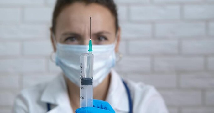 Immunity stimulation with injection. A doctor testing a vaccine for immunity stimulation in the cabinet.