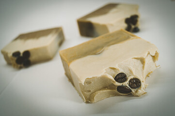 Handmade soap with coffee aroma and coffee beans. Selective focus, film grain