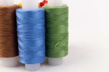 Color sewing threads isolated on white background. Different colors.Bright bobbin thread.