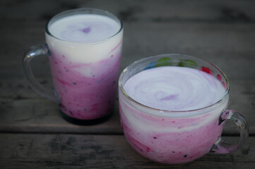 Kefir with jam in glass mug of different sizes. Healthy eating. Delicious dessert. Blur, noise, grain, selective focus