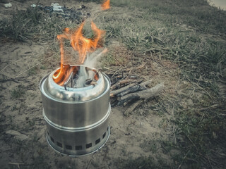 Mini camping stove. Tourist equipment for cooking. Selective focus, copy space