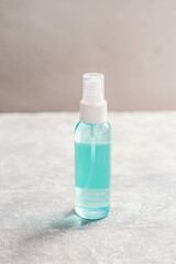 medical equipment For stopping and reducing the spread of Covid-19 coronavirus, alcohol-based antibacterial hand sanitizer spray on gray background.