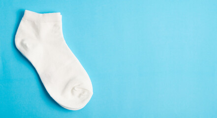 White socks on blue background and space for text.