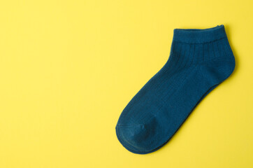 Dark blue socks on yellow background and space for text.