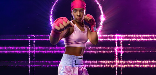 Boxing. Teenager boxer in neon lights. Kids sport concept. Girl sportsman muay thai boxer fighting...