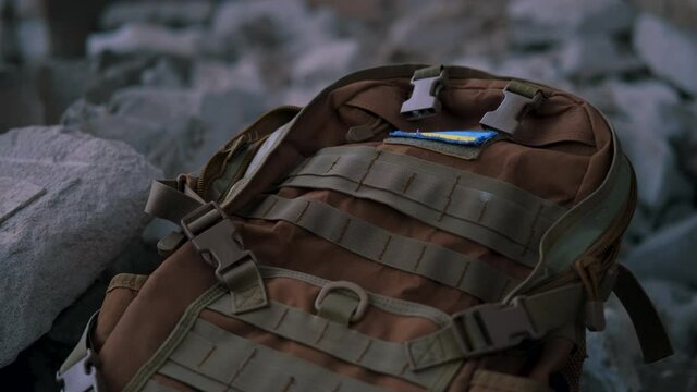Military backpack in the ruins after the war