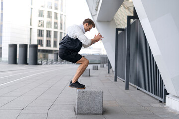 Young sportsman jumping up on box, training outdoors