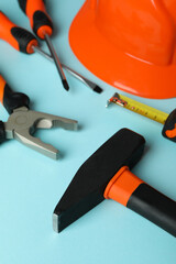Work tools on blue background, close up