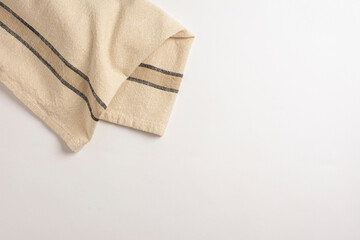 Stripped kitchen towel isolated on white background. Top view of folded linen napkin isolated on...