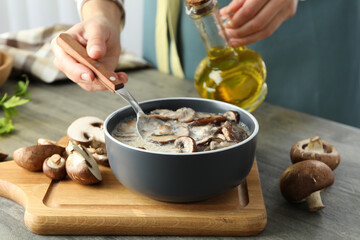 Concept of tasty food with mushroom sauce on gray textured table