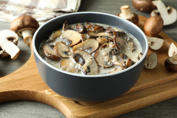 Concept of tasty food with mushroom sauce on gray wooden background