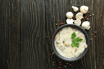Concept of tasty food with mushroom sauce on wooden background