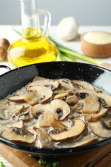 Concept of tasty food with mushroom sauce on with wooden table