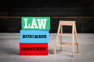 Consumer and Business Law concept. Colored wooden blocks in a pile and stairs