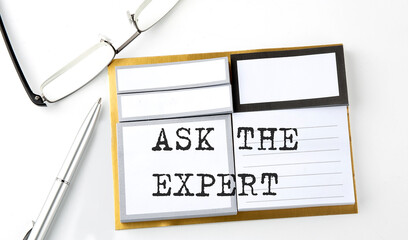 ASK THE EXPERT text on sticky notes with glasses and pen, business concept