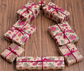 creative tree and christmas gifts on rustic background