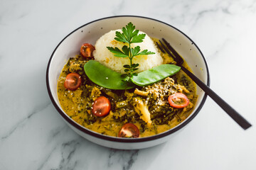 vegan thai green curry with rice and mixed vegetables, healthy plant-based food